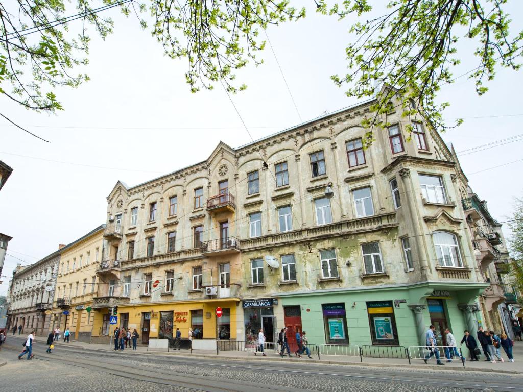 a large building on the side of a street at Aparthotel NA DOBU in Lviv