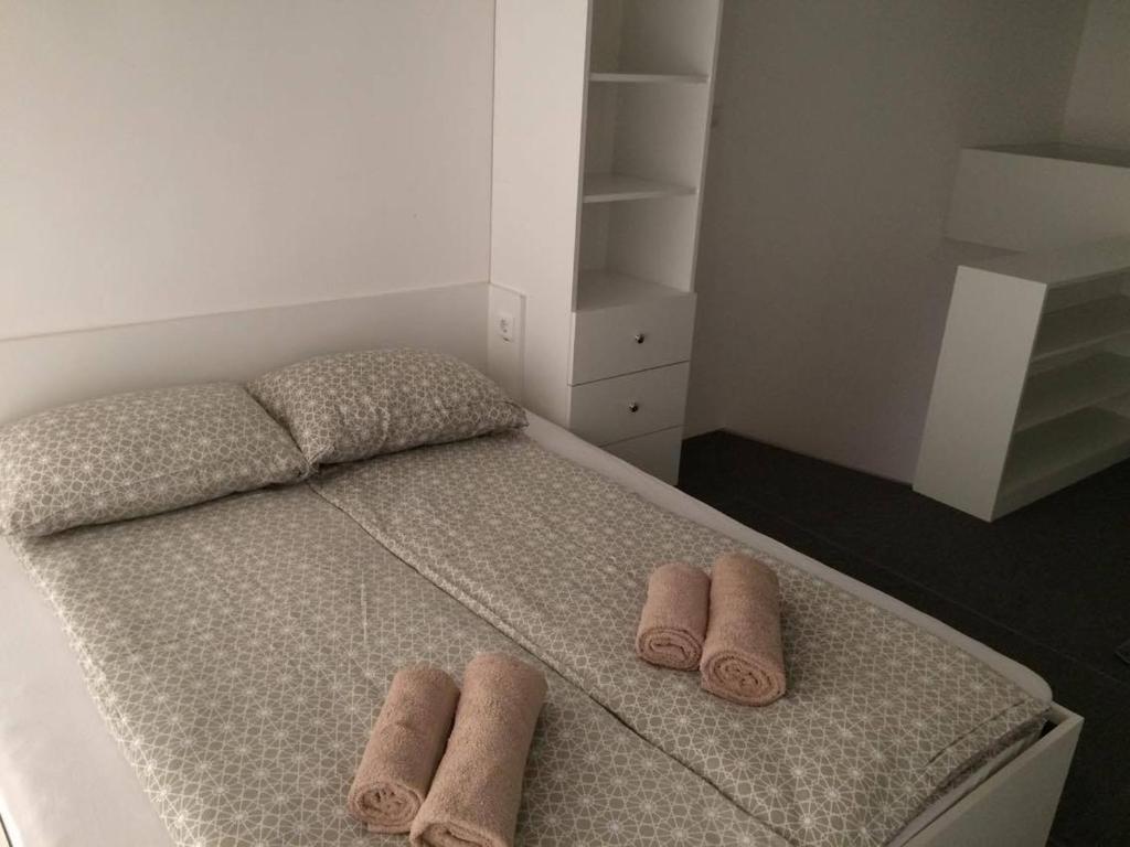 a bedroom with a bed with two towels on it at Apartment Luka in Portorož