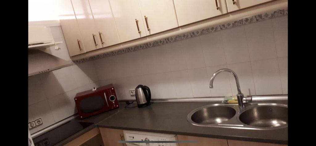 A kitchen or kitchenette at JSM Apartamentos