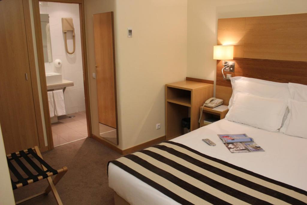 Postel nebo postele na pokoji v ubytování Hotel Principe Lisboa