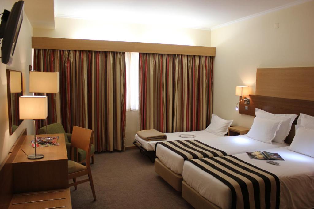 Postel nebo postele na pokoji v ubytování Hotel Principe Lisboa