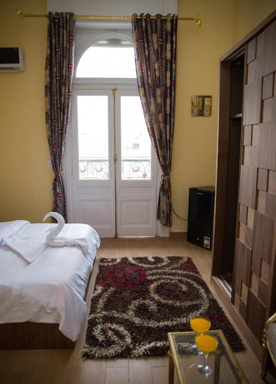 Postel nebo postele na pokoji v ubytování New Grand Royal Hotel Cairo