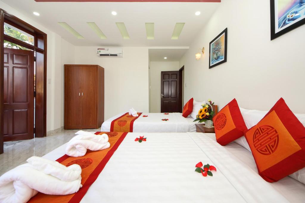 Postel nebo postele na pokoji v ubytování Hoi An Dat Cam Homestay