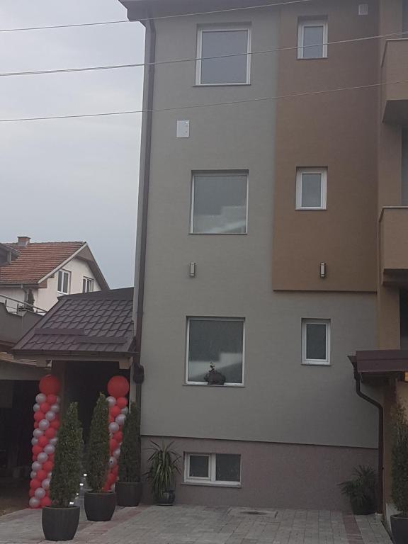 a building with red and white balloons in front of it at Hotel Kiko in Bitola