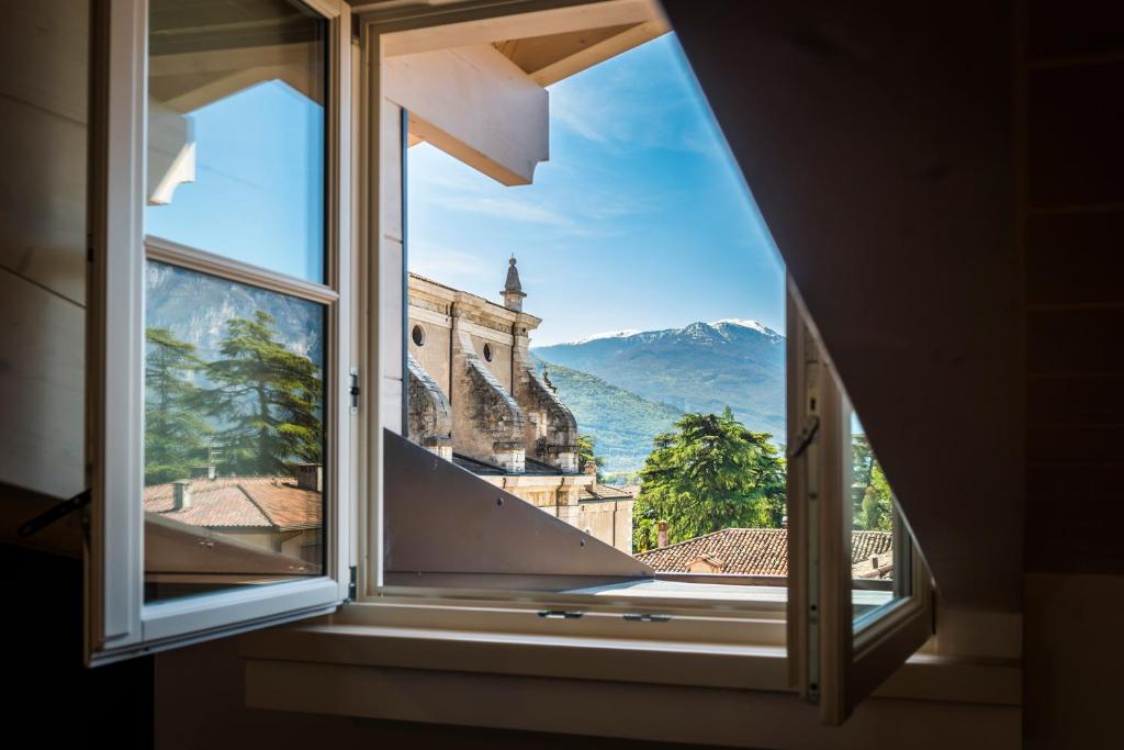 okno z widokiem na góry w obiekcie Casa Tonetta Luxury Apartments w Arco