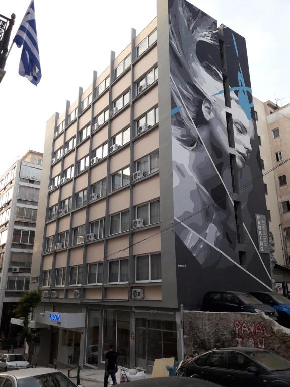 a building with a large painting on the side of it at Filon in Piraeus