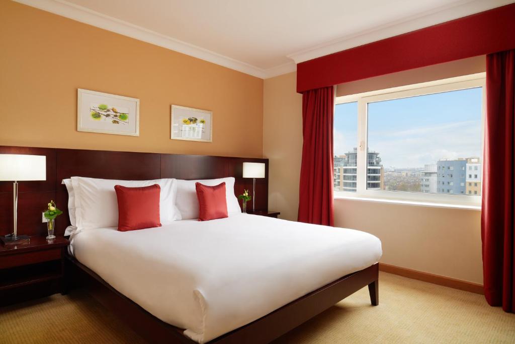 a bedroom with a large bed and a large window at The Chelsea Harbour Hotel and Spa in London