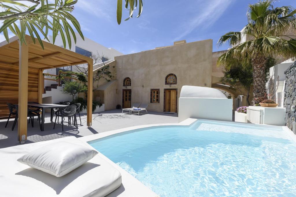 a swimming pool in the middle of a patio at Casasantantonio 18th Century Luxury Mansion in Fira