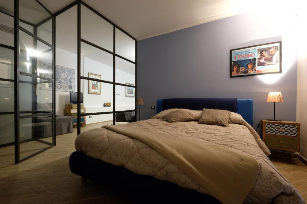 a bedroom with a large bed and a blue wall at Casa Margherita in Modica
