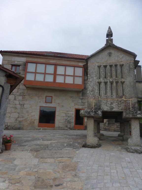 a large stone building with windows and a fireplace at Casa Bravo in Gondomar