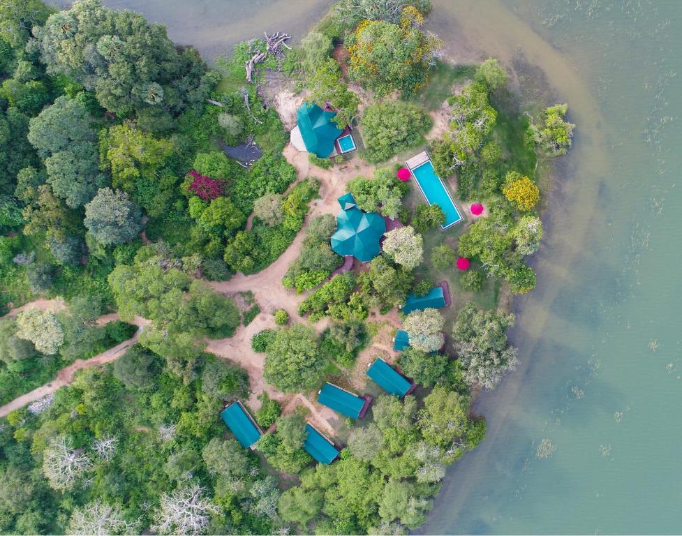 an aerial view of an island with trees and water at Flameback Eco Lodge in Tissamaharama