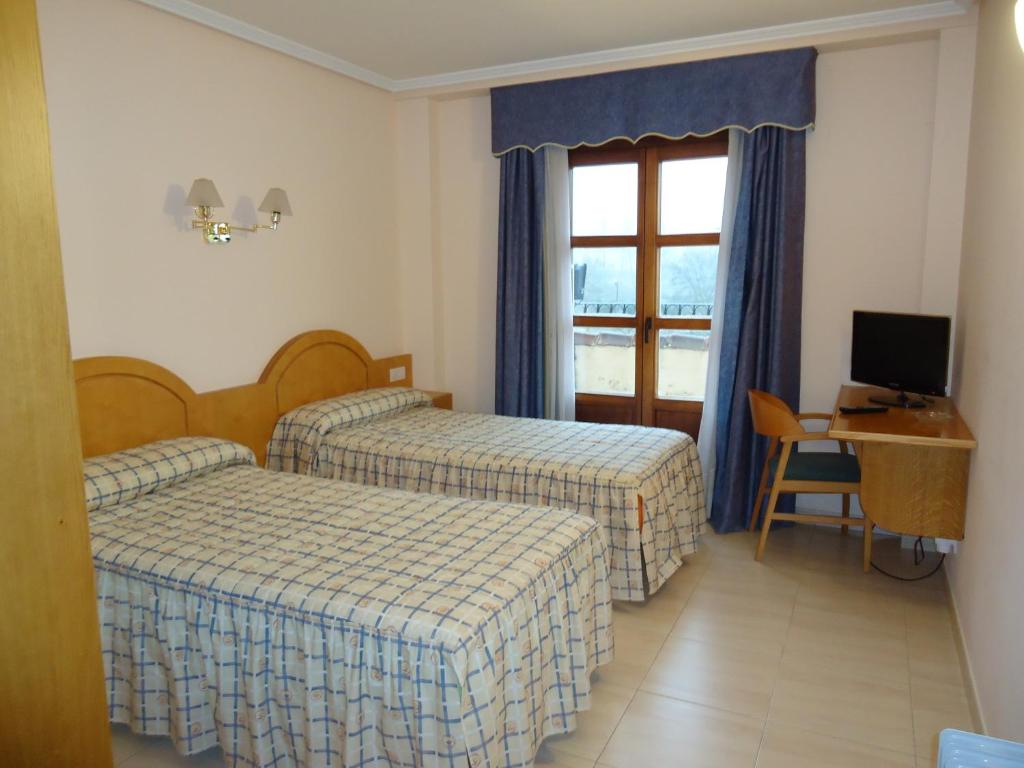 Postel nebo postele na pokoji v ubytování Hotel Silos 2000