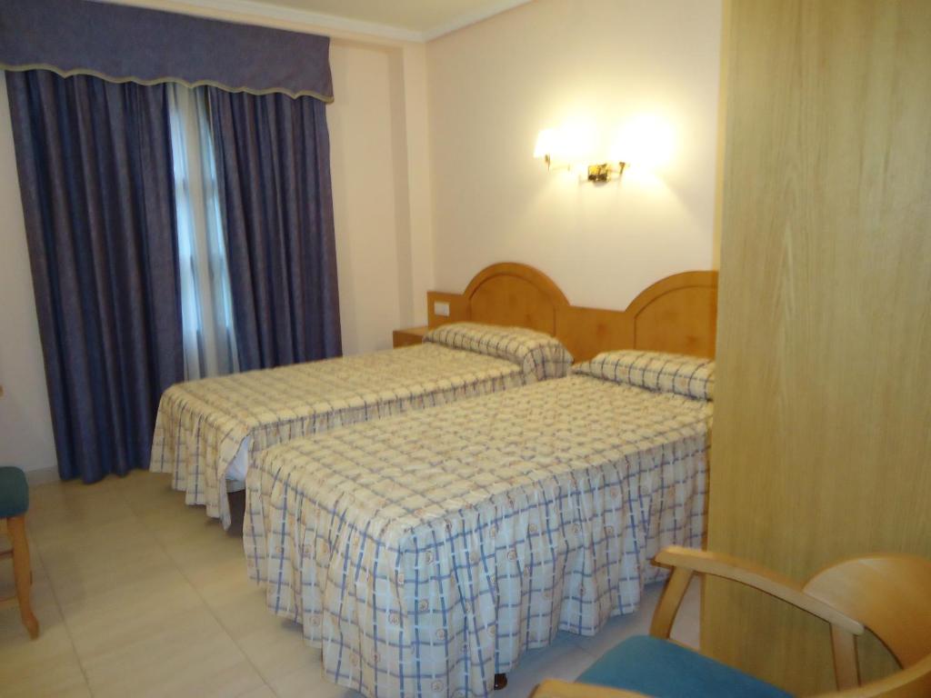 Postel nebo postele na pokoji v ubytování Hotel Silos 2000