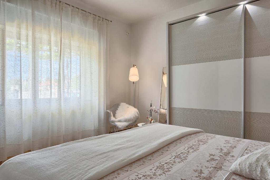 Postel nebo postele na pokoji v ubytování Apartments Vlasta