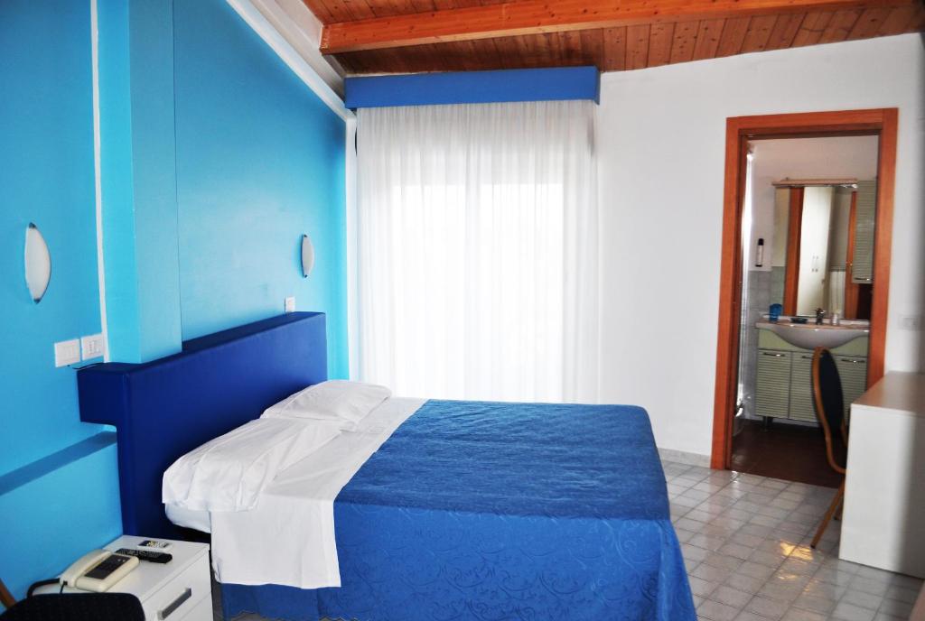 Postel nebo postele na pokoji v ubytování Hotel Albatros