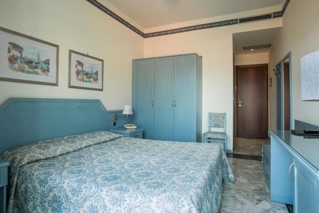 Postel nebo postele na pokoji v ubytování Hotel Ariston