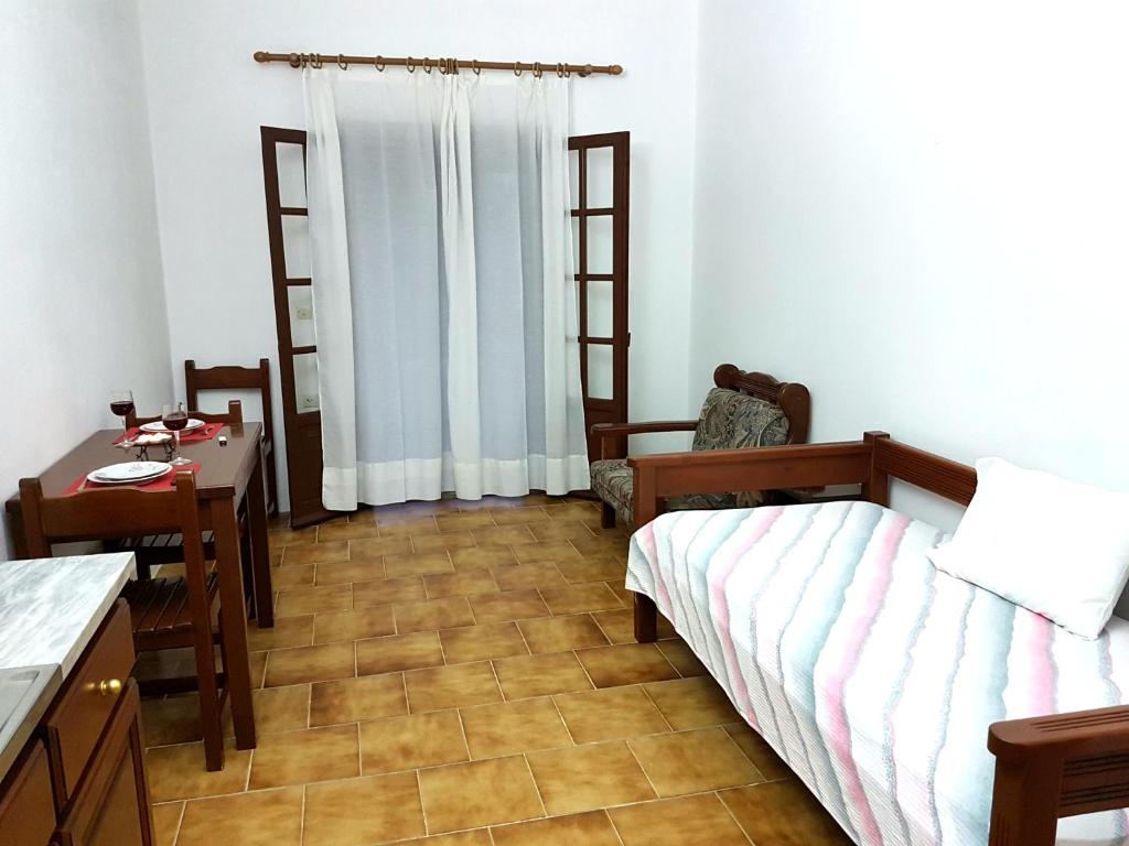 A bed or beds in a room at Alexandros Studios