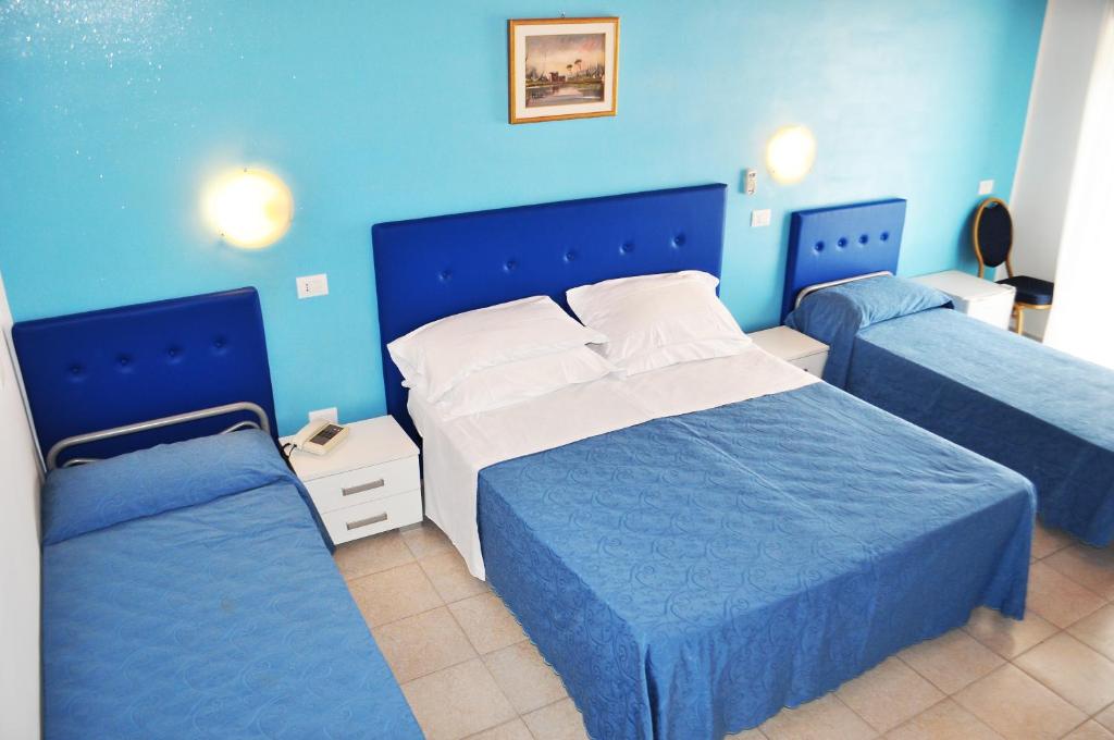 Postel nebo postele na pokoji v ubytování Hotel Albatros