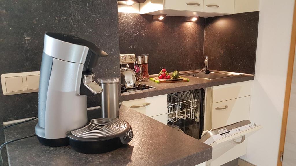 a kitchen with a coffee maker on a counter at Ferienwohnung am Betzelhübel in Ottweiler