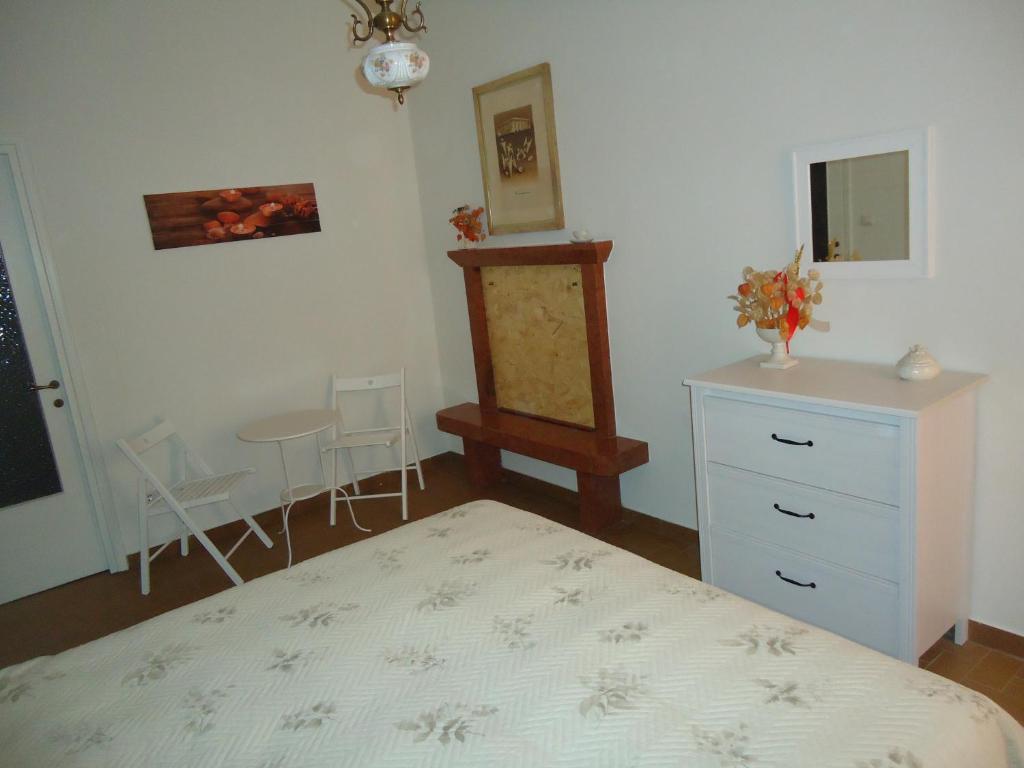 a bedroom with a bed and a dresser and a table at Casa Vacanze Centro Storico Verona in Verona