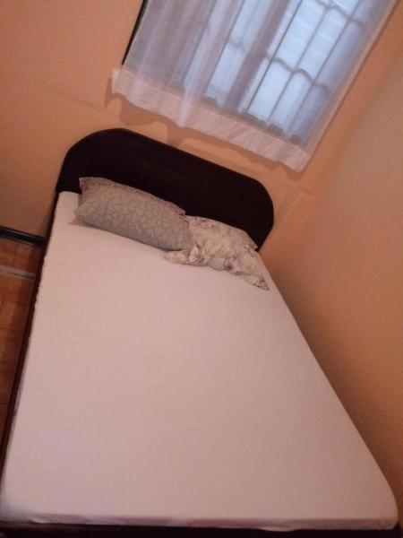 Postel nebo postele na pokoji v ubytování Hotel Latino