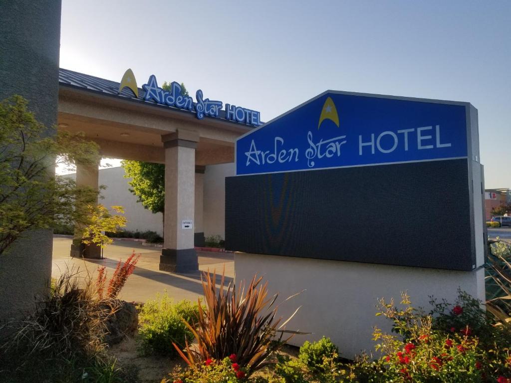 a sign for a hotel in front of a building at Arden Star Hotel in Sacramento