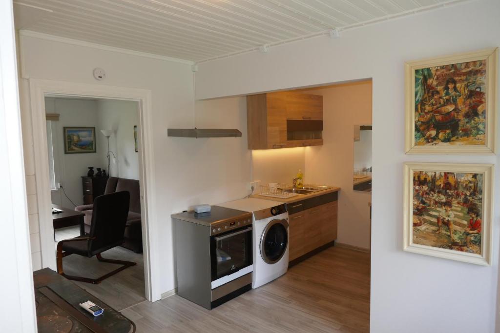 a kitchen with a washing machine in a room at Kärdla Holiday House in Kärdla