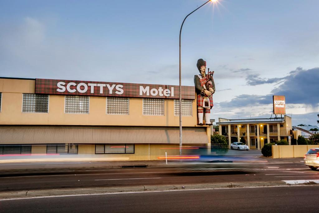 a building with a sign on the side of it at Scotty's Motel in Adelaide