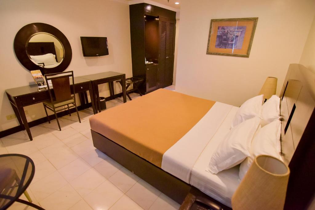 Postel nebo postele na pokoji v ubytování Hotel Tavern Surigao