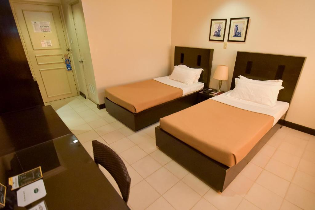 Postel nebo postele na pokoji v ubytování Hotel Tavern Surigao