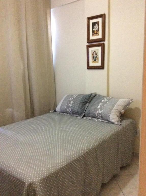 a bed in a bedroom with two pillows on it at Coração de Copacabana in Rio de Janeiro