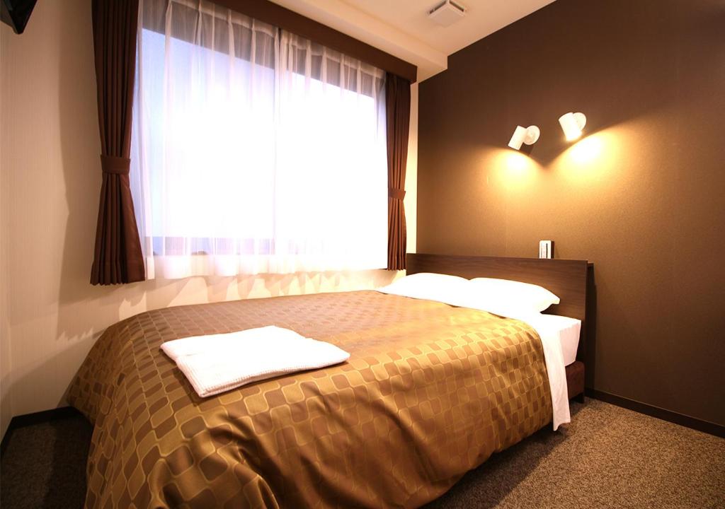 Postel nebo postele na pokoji v ubytování Hotel Trend Asakusa Annex