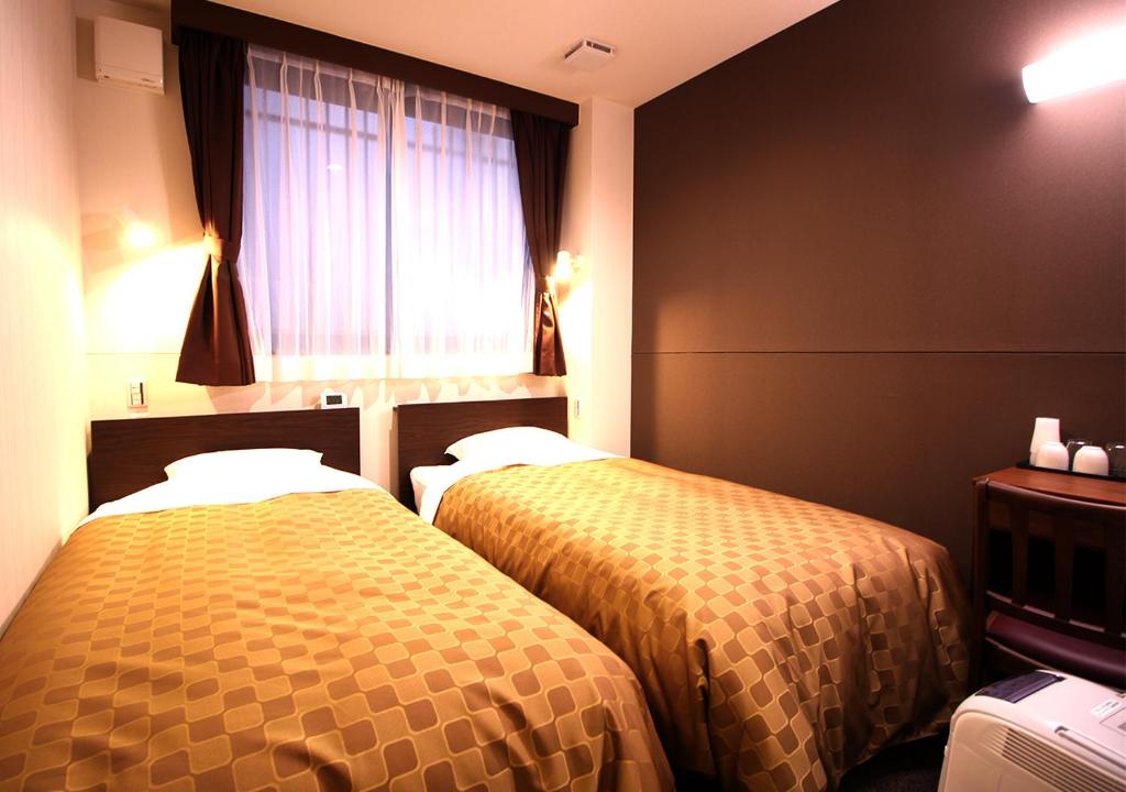Postel nebo postele na pokoji v ubytování Hotel Trend Asakusa Annex
