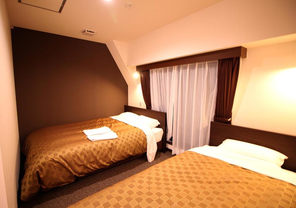 Postel nebo postele na pokoji v ubytování Hotel Trend Asakusa Annex