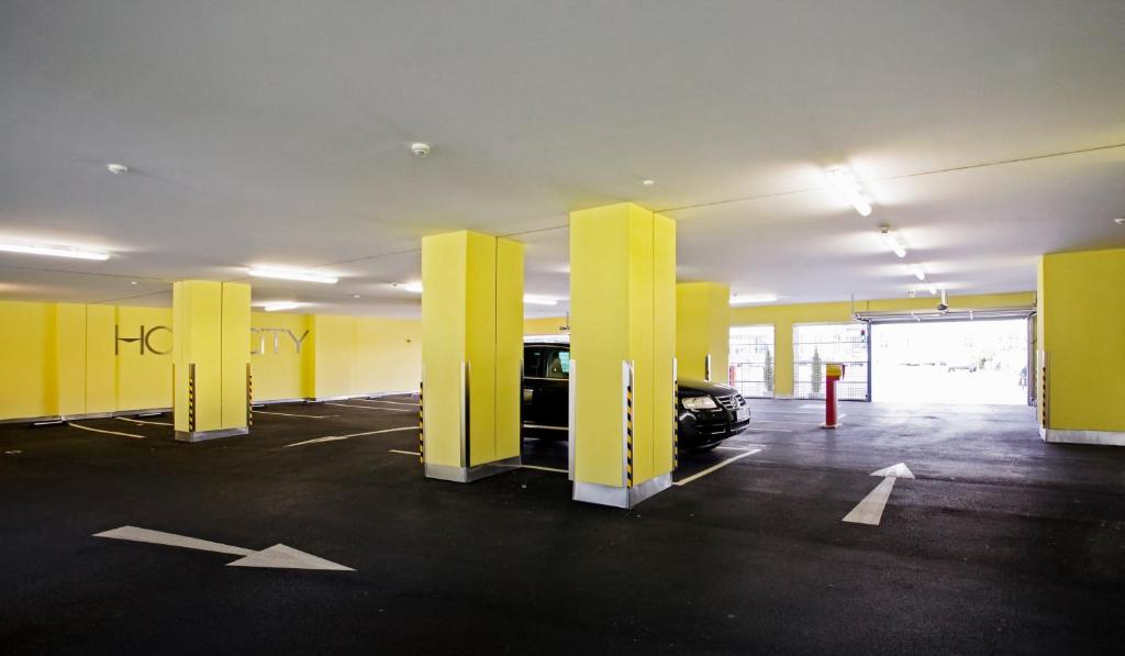 a parking lot with yellow dividers in a parking garage at Hotel City in Villach