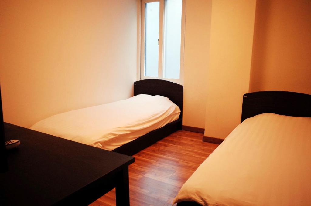 Cama ou camas em um quarto em YaKorea Hostel Gangnam