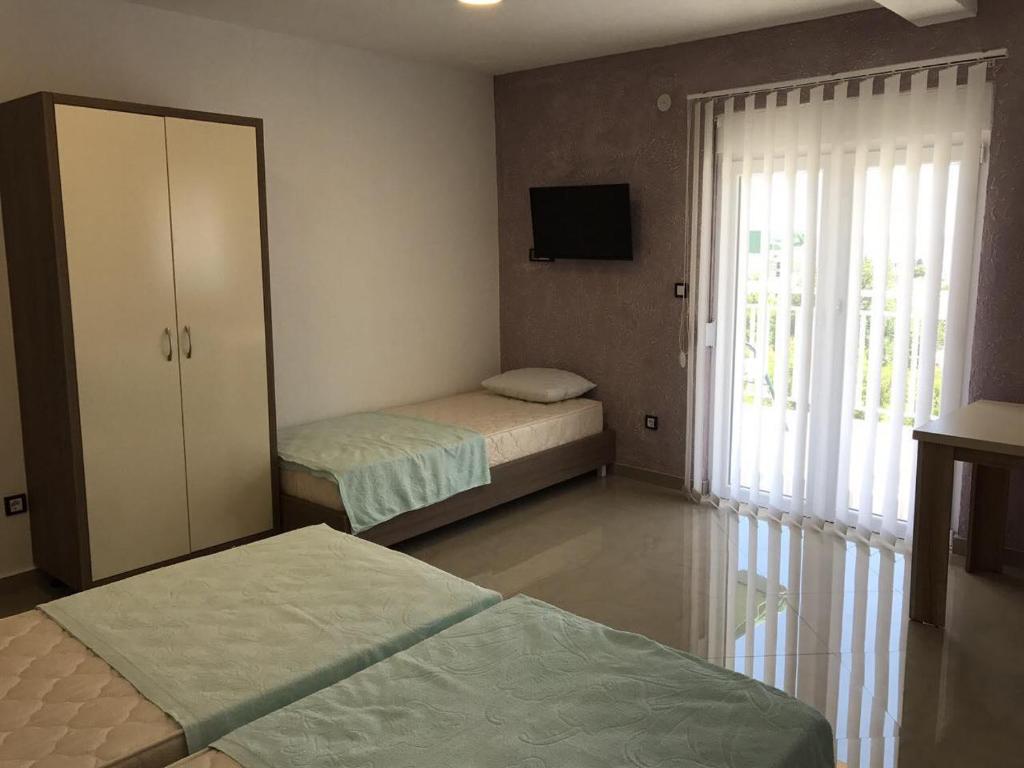 Postel nebo postele na pokoji v ubytování Vip Apartmani Canj