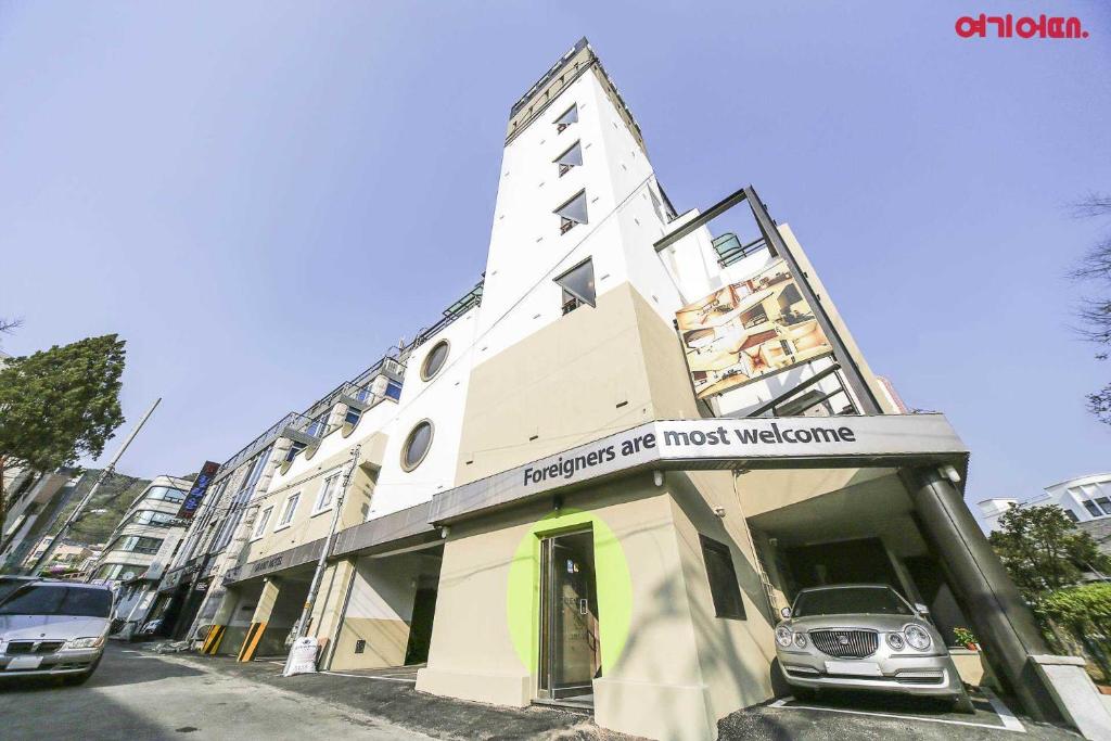 a building with a car parked in front of it at Goodstay Grand Motel Chuncheon in Chuncheon