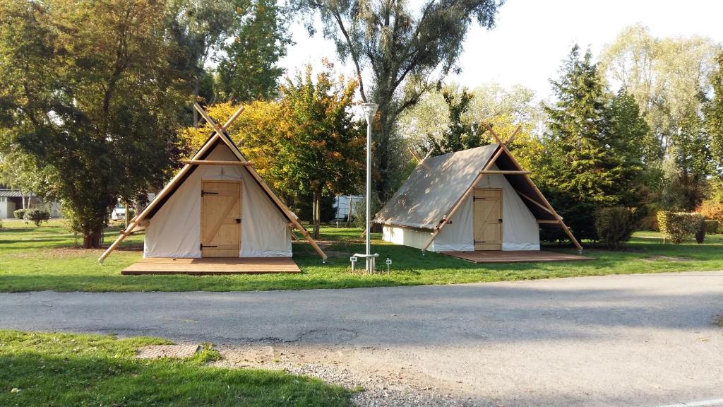 two tents sitting on the side of a road at Camping Du Port De Plaisance in Péronne
