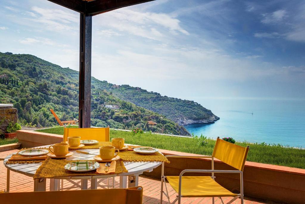 a table and chairs with a view of the ocean at Terrazza Marina in Porto Santo Stefano