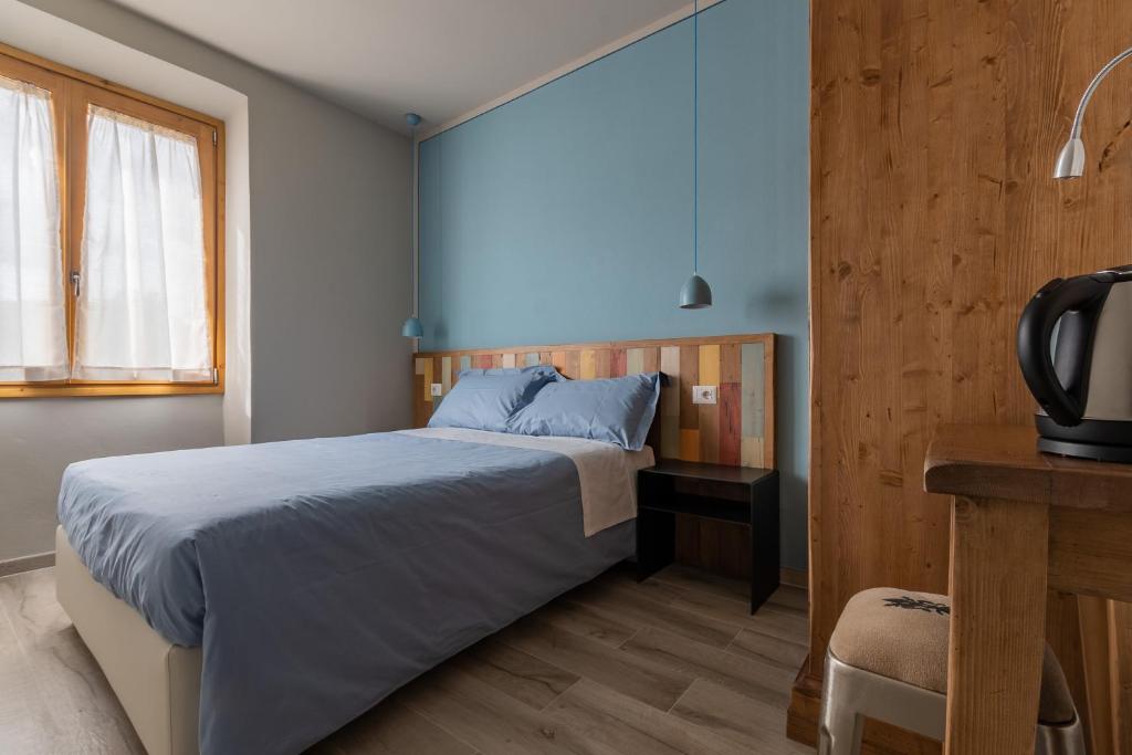 a bedroom with a bed and a desk and a television at B&B L'Eroico in Gaiole in Chianti