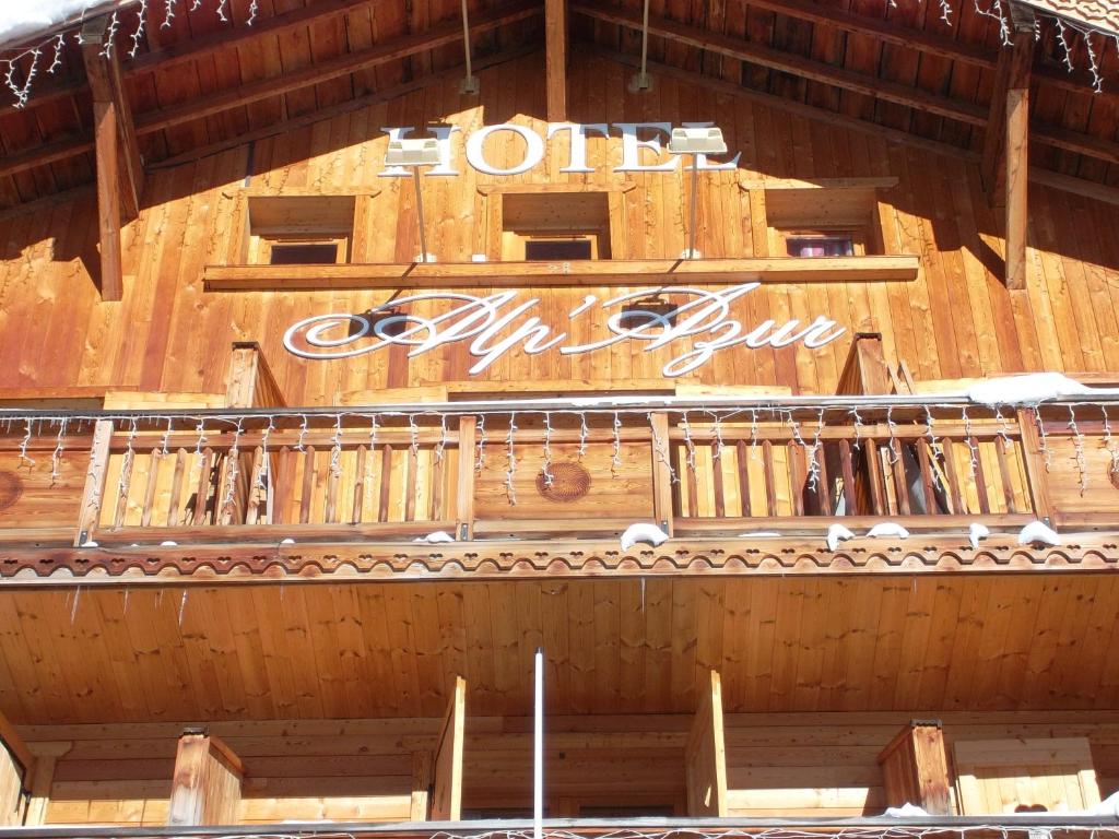 a wooden building with a sign on top of it at Alp'azur in L'Alpe-d'Huez
