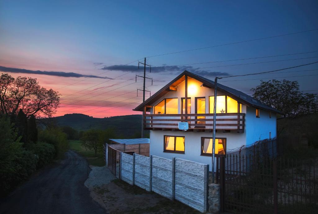 a house with its lights on at sunset at Casa City View in Sibiu