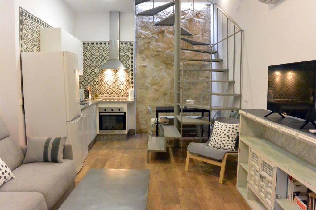 a living room with a couch and a staircase at Casa del Portillo-Centro Histórico in Córdoba