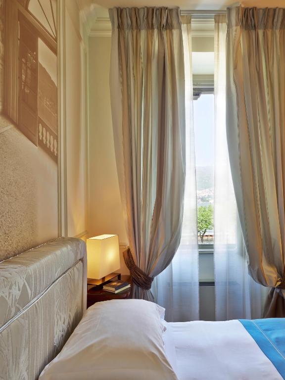 Una cama o camas en una habitación de Albergo Terminus