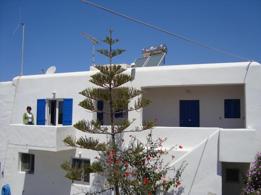 a christmas tree on the side of a white building at Marina Blue Ornos in Ornos