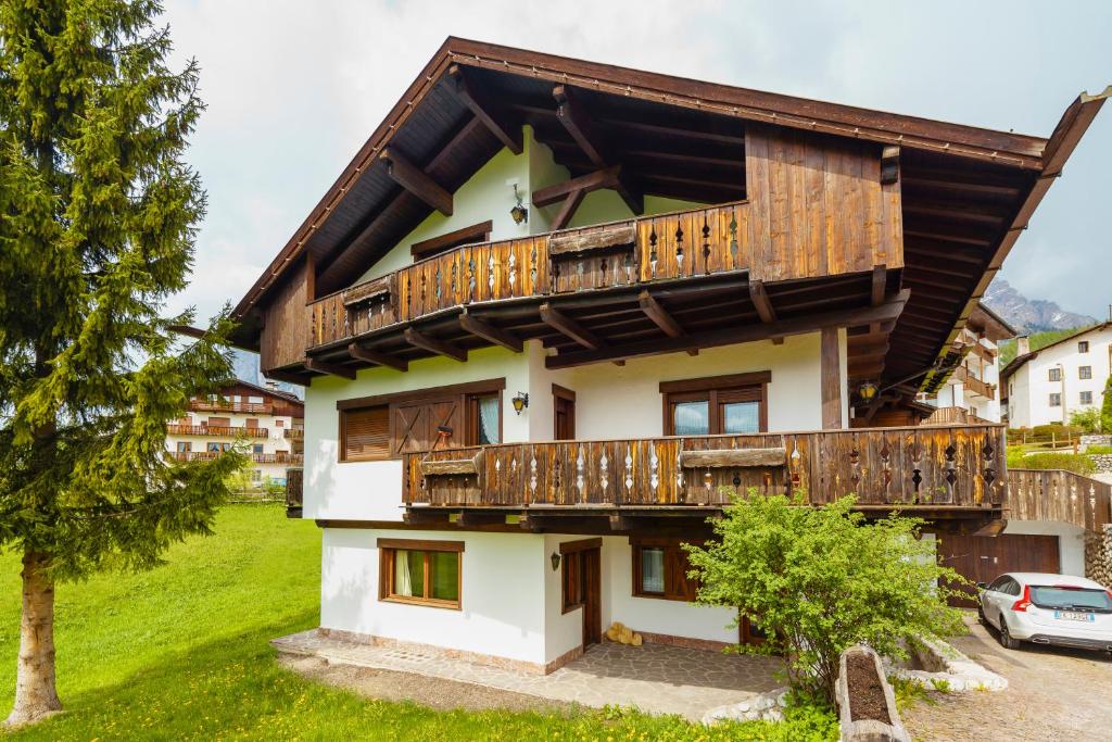 una casa con balcones de madera encima en Villa Ca Perosego - Stayincortina, en Cortina dʼAmpezzo