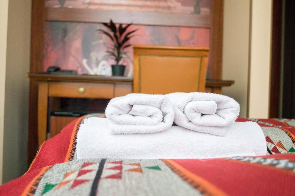Postel nebo postele na pokoji v ubytování Petra Hotel