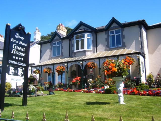 a house with a sign in front of it at Bron Menai Guest House in Caernarfon