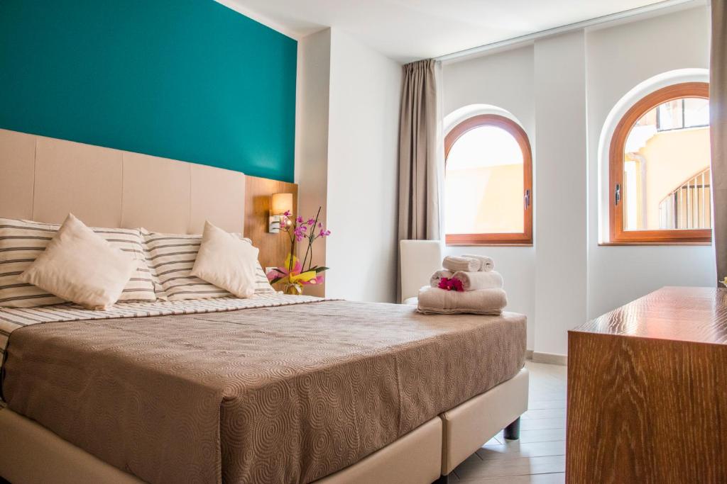 Postel nebo postele na pokoji v ubytování Hotel Maria